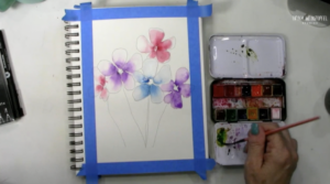 adding paint to watercolor flowers