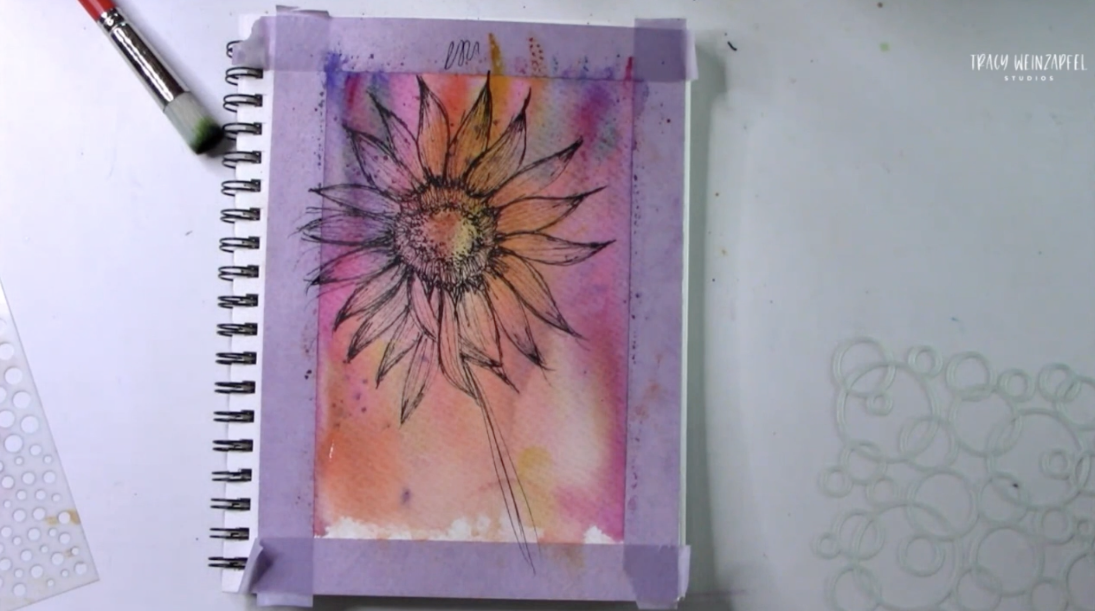 sketching a flower in an art journal 