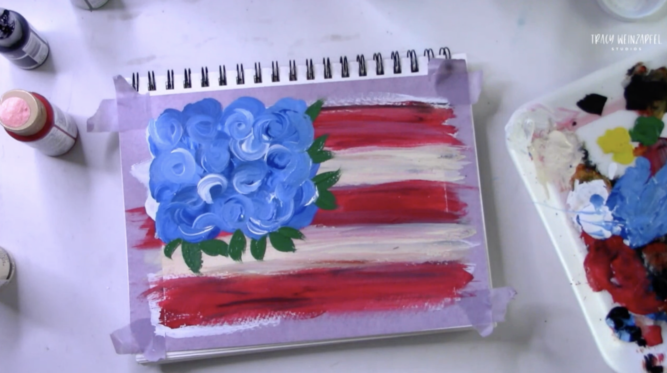 painting blue flowers on the american flag