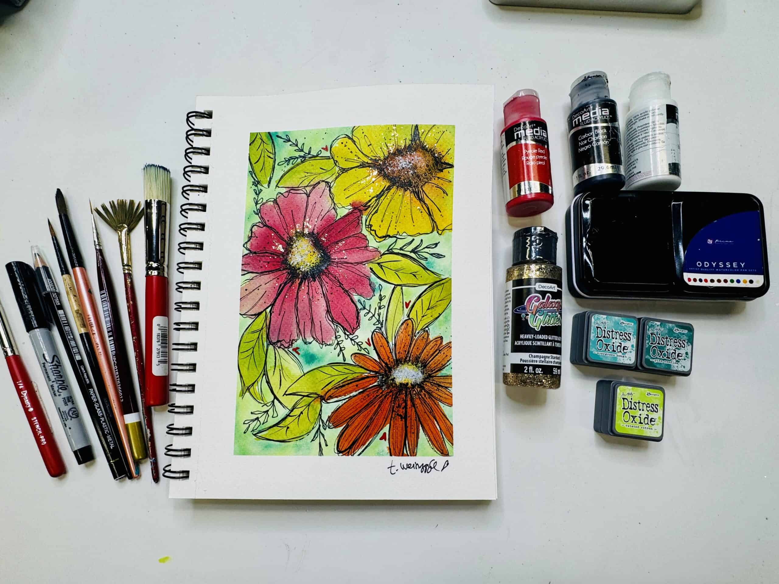 finished watecolor flowers art journal page with supplies