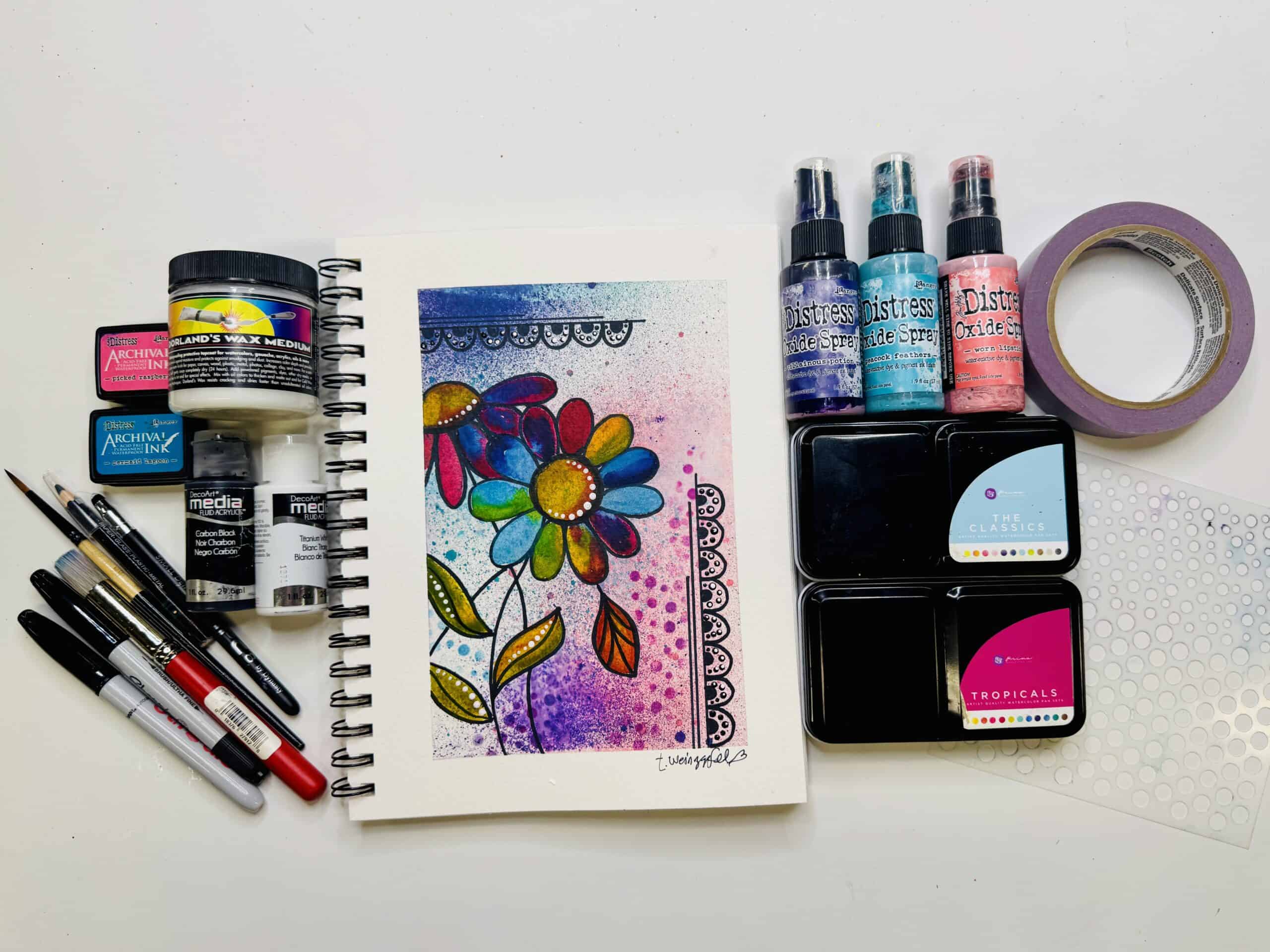 finished art journal page with supplies