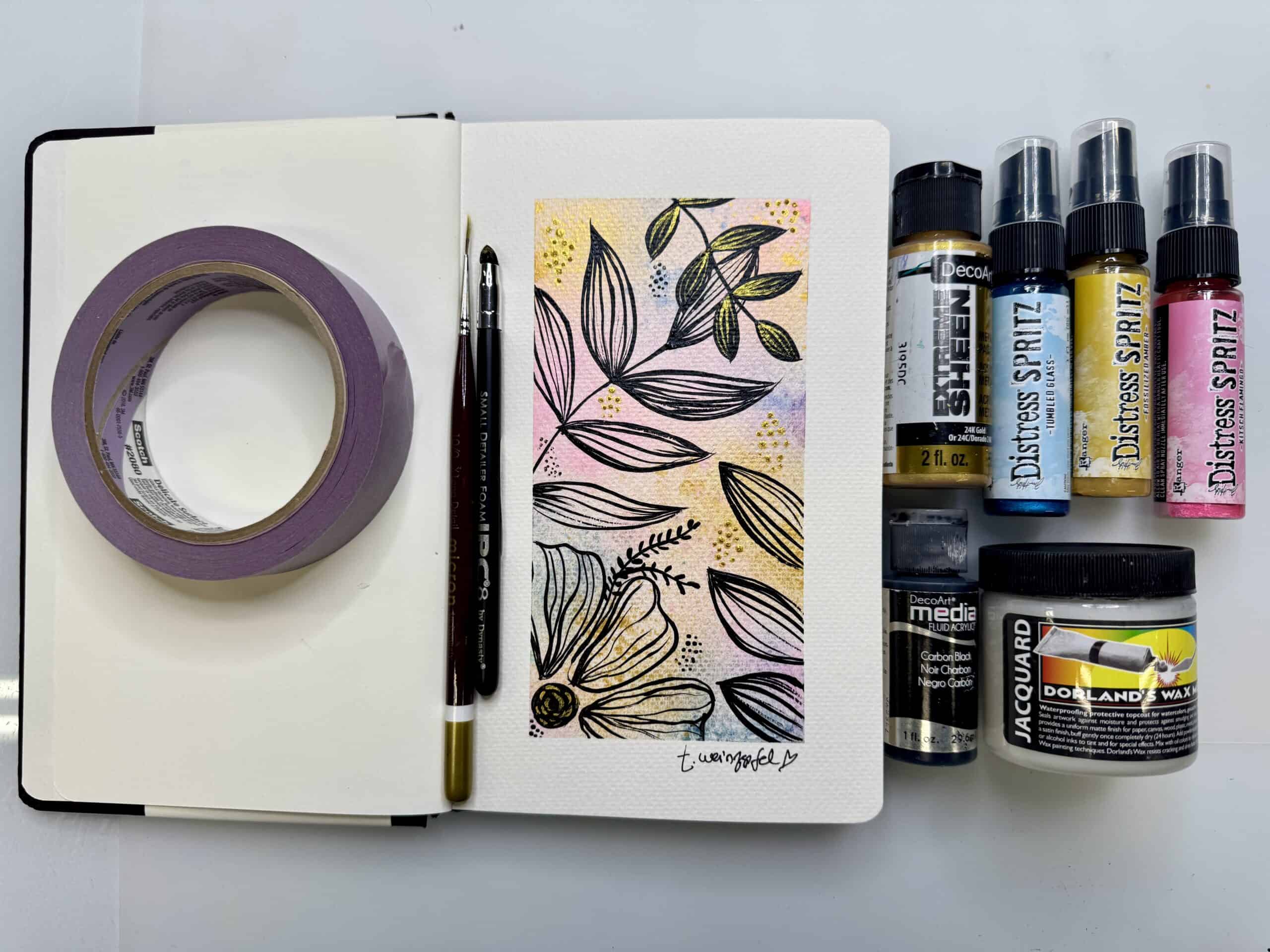 finished leaves art journal page with supplies