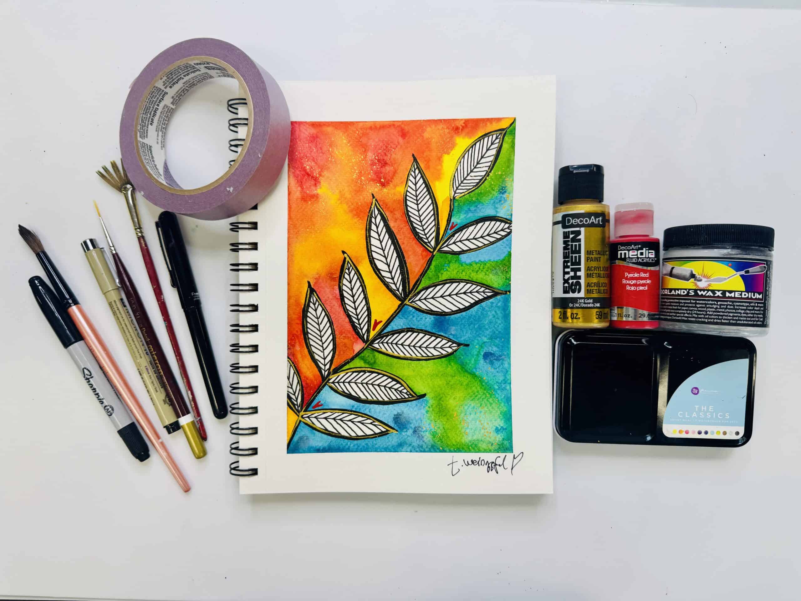 finished art journal page with supplies